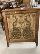 Arts & Crafts: Oak fire screen with inset tapestry panel depicting peacocks.