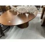 Quatropi walnut dining table the oval top with inset circular central glass panel supported by a