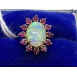 Jewellery: Ring yellow metal oval cluster set with an oval cabouchon cut opal, estimated weight 3.
