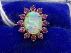 Jewellery: Ring yellow metal oval cluster set with an oval cabouchon cut opal, estimated weight 3.