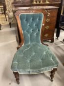 Aesthetic nursing chair with carved framework, upholstered back and seat on turned legs with brass