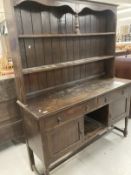 Early 20th cent. Stained oak dresser with two shelves, two drawers and two cupboards on turned