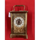 Clocks & Watches: 20th cent. Brass carriage timepiece with enamel face and Roman numerals, foliate