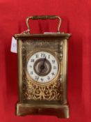 Clocks & Watches: 20th cent. Brass carriage timepiece with enamel face and Roman numerals, foliate