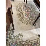 Carpets & Rugs: British made ivory ground woolen carpet with central floral decoration with a