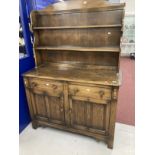 20th cent. Dark oak dresser and rack, the top with two shelves, the base with two drawers above