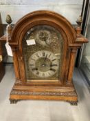 Clocks & Watches: Early 20th cent. German oak cased mantel clock with gilt and white face, applied