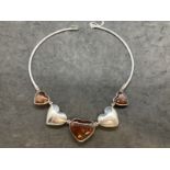 Hallmarked Silver: Torque necklet at the centre are five evenly spaced graduated hearts, three set