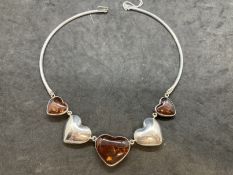 Hallmarked Silver: Torque necklet at the centre are five evenly spaced graduated hearts, three set