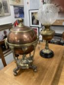 Early 20th cent. Brass oil lamp on a black porcelain mount, topped with a glass chimney and a