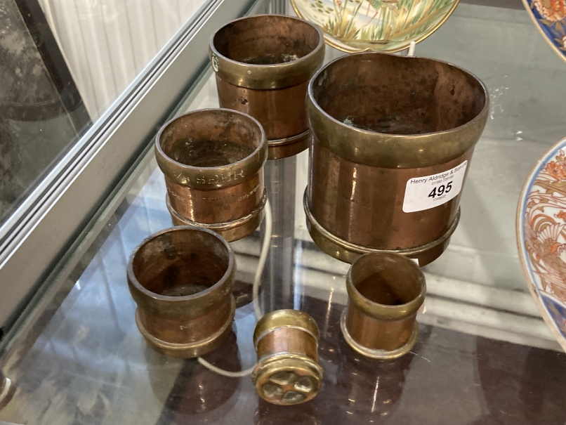Oriental: Set of six seer measuring cups in copper with brass banding. Sizes from 1/64 to half a