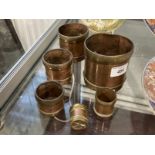 Oriental: Set of six seer measuring cups in copper with brass banding. Sizes from 1/64 to half a