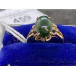 Jewellery: Ring yellow metal set with an oval cabouchon cut jade, estimated weight 3.00ct, with a