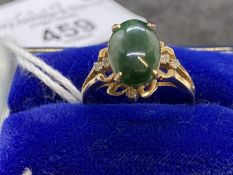 Jewellery: Ring yellow metal set with an oval cabouchon cut jade, estimated weight 3.00ct, with a