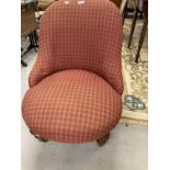 Victorian upholstered nursing chair on turned legs to the front with castors. 31ins. x 25ins.