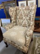 19th cent. Paisley upholstered high wing back chair, front pad feet sloping rear supports. Height