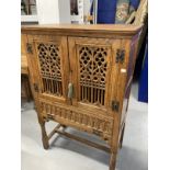 20th cent. Gothic style oak larder cupboard with two pierced and carved doors above a single fall,