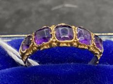 Jewellery: Yellow metal half hoop ring set with five graduated amethysts, estimated weight of (5)