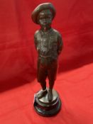 C. Kundonmann: Bronze figure of a boy smoking a Cheroot raised on a black marble base, signed C.