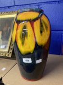 Poole: Large dark blue ground vase decorated with yellow flowers. 13ins.