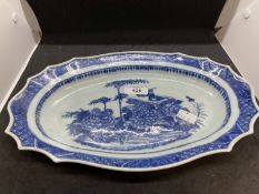 Oval serpentine dish with chrysanthemums and auspicious symbols, with restoration. A/F