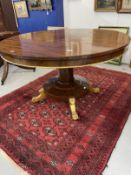 19th cent. Mahogany tilt top table, the round top supported by a central column to a round base with