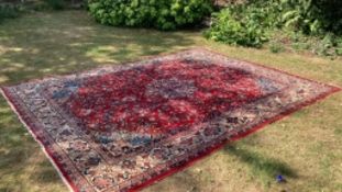 Carpets: A good red ground Wilton Persian rug, cost when new approx. £1500. 111ins. x 151½ins.