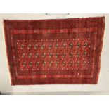 Carpets & rugs: 19th cent. Turkman rug, red ground with a central panel containing forty guls,