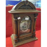 Clocks: German oak cased mantle clock Wurttemberg with brass spandrels and silvered dial. 17½ins.