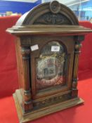 Clocks: German oak cased mantle clock Wurttemberg with brass spandrels and silvered dial. 17½ins.