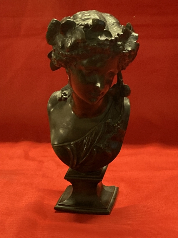 After A. Carrier bronze of a lady on a shaped base with ivy in her hair, signed A. Carrier. 8ins.