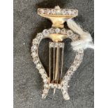 Jewellery: Yellow metal brooch in the form of a lyre set with forty-two rose cut diamonds, estimated