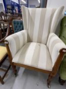 Mid 19th cent. Continental fruitwood wingback armchair on turned front supports terminating in brass