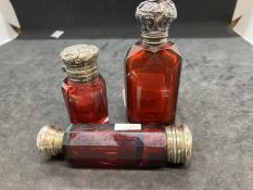 Glass: 19th cent. Ruby glass, white metal topped scent bottles. (3)