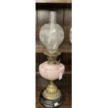 Victorian oil lamp black ceramic base, brass base pink glass reservoir, round etched shade. 23ins.