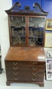 George III mahogany bureau bookcase c1770 with fret carved swan neck pediment above a pair of