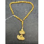 Jewellery: Islamic prayer beads consisting of (33) butterscotch amber beads with a drop at the