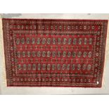 Carpets & Rugs: Late 19th/early 20th cent. Turkman rug, red ground with a central panel containing