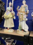 Ceramics: Porcelain figures, young lady and a gentleman holding flowers, on round bases, base