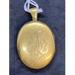 Jewellery: Yellow metal Victorian oval hinge locket, front cover engraved, tests as 18ct gold.