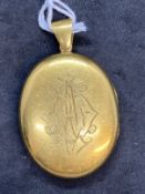 Jewellery: Yellow metal Victorian oval hinge locket, front cover engraved, tests as 18ct gold.