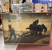 20th cent. Print: A farmer ploughing a field, framed and glazed. 35ins. x 55ins.