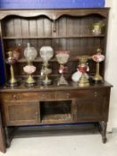 Early 20th cent. Stained oak dresser with two shelves, two drawers and two cupboards on turned