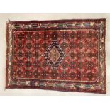 Rugs: Turkish style rug in reds and blues. 56ins. x 40ins.