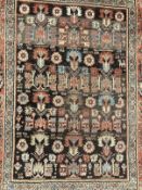 Rugs & carpets: Late 19th cent. Persian rug, black ground central panel decorated with stylised