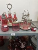 Glass: 19th cent. Cranberry glass cruet set in plated stand six bottles and stoppers, one bottle