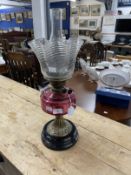 Victorian oil lamp black ceramic base, brass column, cranberry glass reservoir, clear glass shade,
