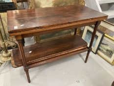 20th cent. Stained pine tea table with carved supports and two leaves.