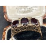 Hallmarked Jewellery: 9ct gold ring set with three oval cut garnets, estimated weight of (3) 3.00ct,