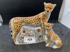 20th cent. Royal Crown Derby porcelain figures of cheetahs, one large and one small.